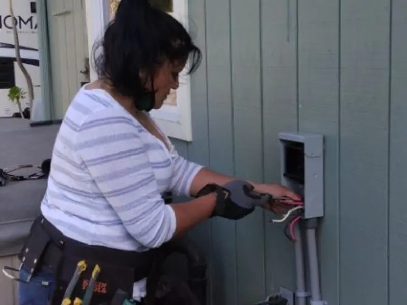 Licensed electrician wiring an exterior subpanel in Williams
